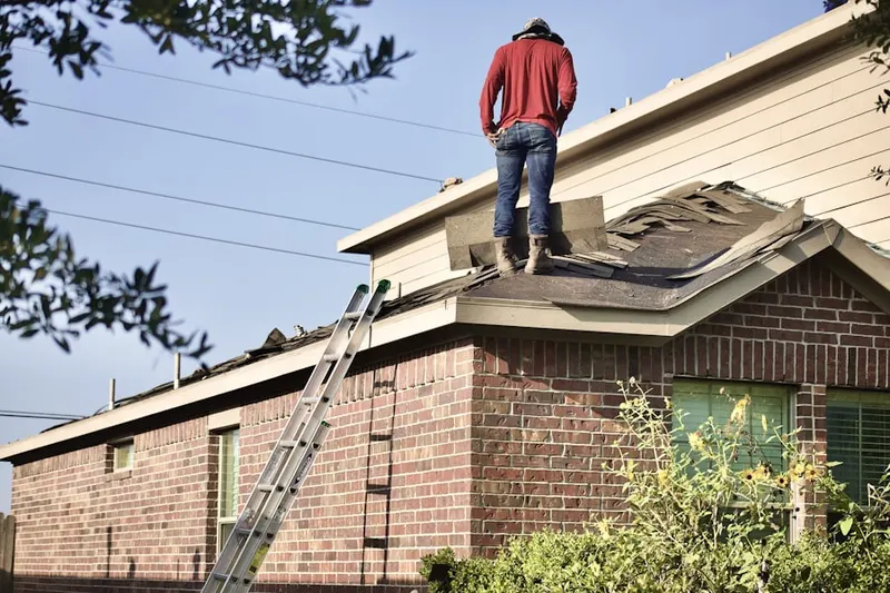 Professional roofer working on a residential roof in Selsie Village
